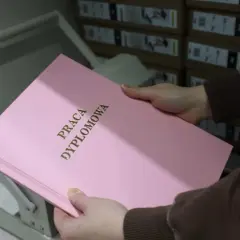 Różowa strona tytułowa pracy dyplomowej z napisem "PRACA DYPLOMOWA" w złoconych literach.